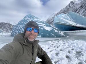 Guest standing on an Alaska glacier during a helicopter glacier landing tour from Homer