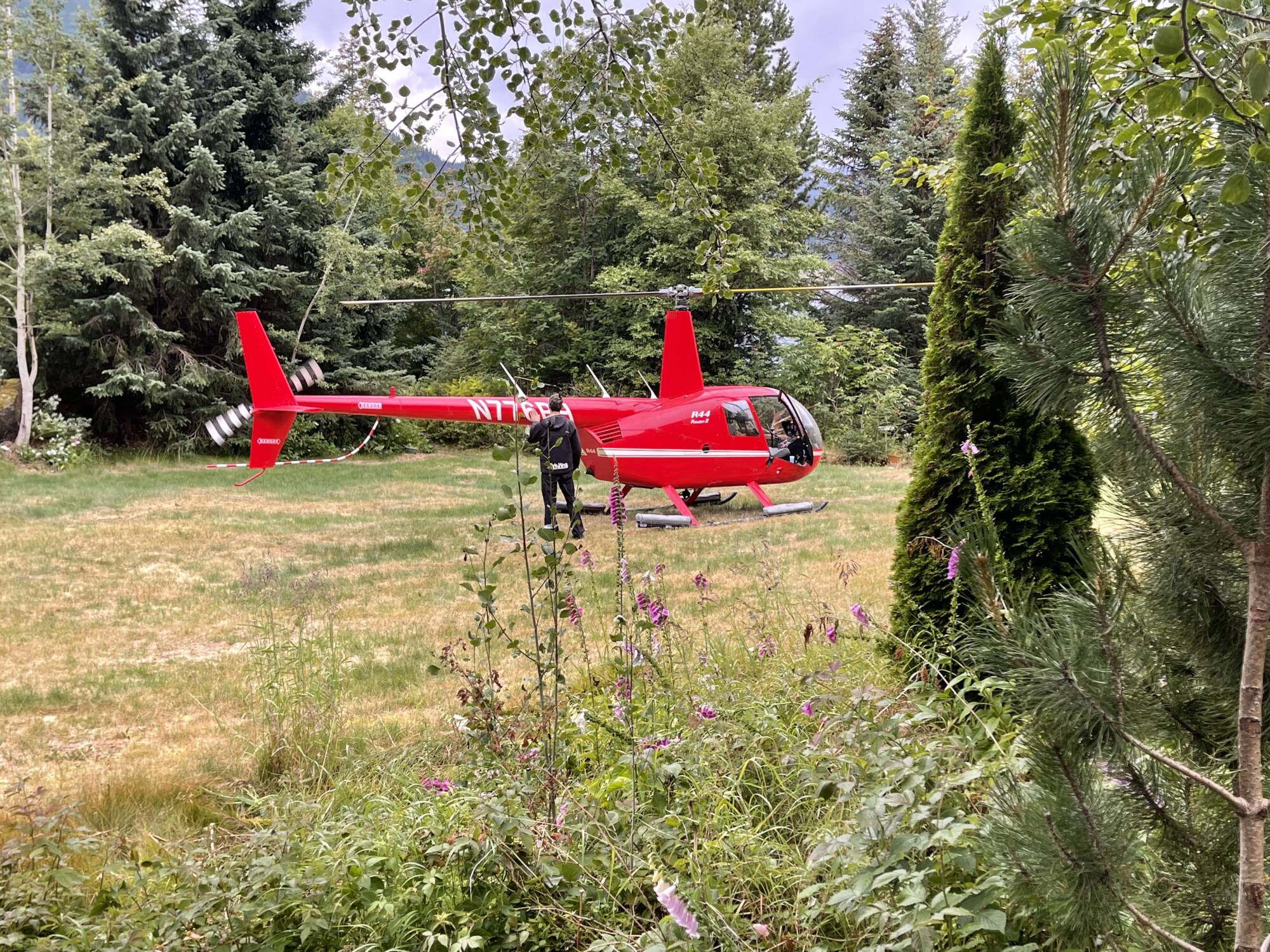 Red helicopter in remote Alaska wilderness during a helicopter bear viewing tour