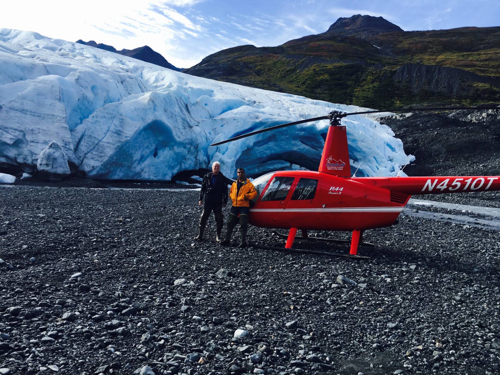 Helicopter on a remote Alaska glacier landing during a Homer flightseeing tour